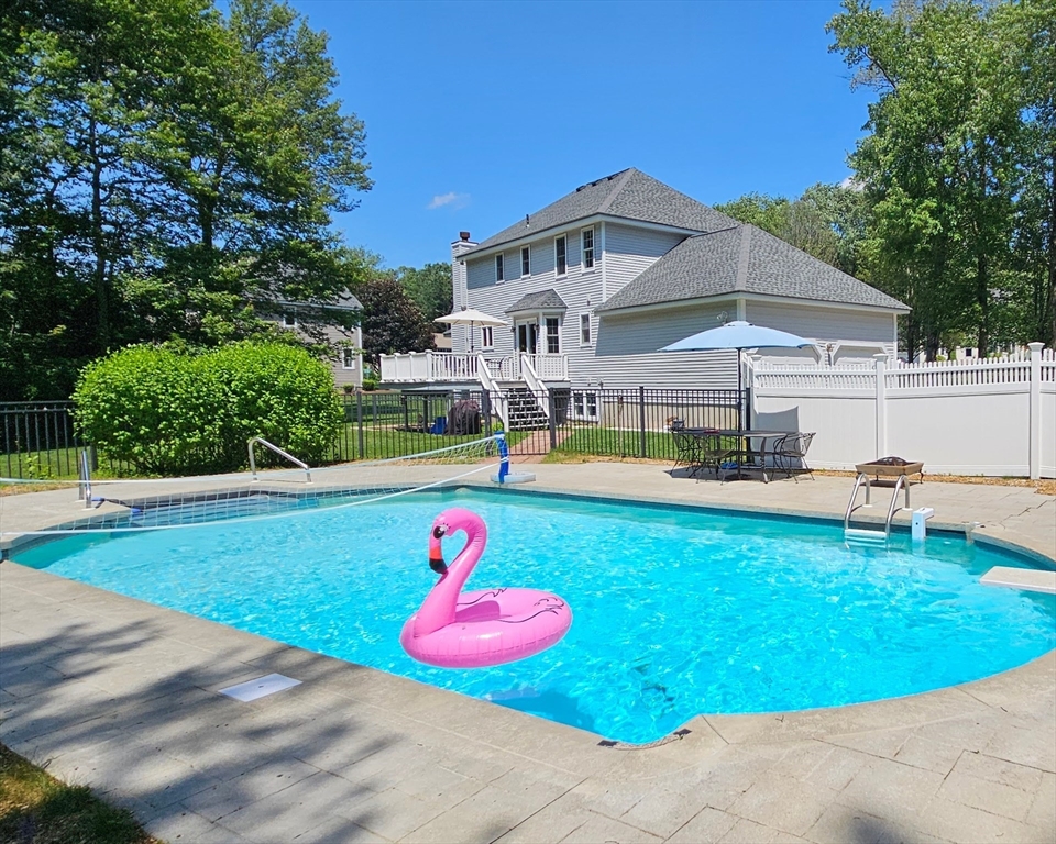 a view of a white house with swimming pool