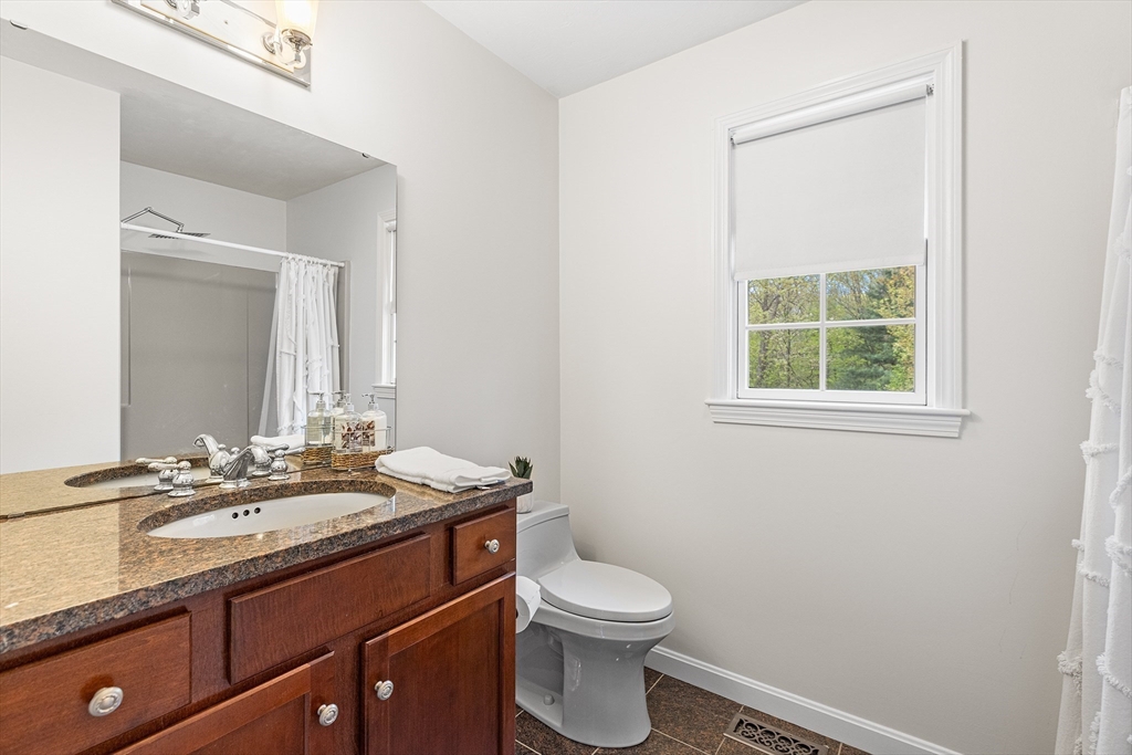 3 Wildflower Drive Sutton, MA 01590 - Photo 16 of 31 a bathroom with a granite countertop sink toilet and mirror