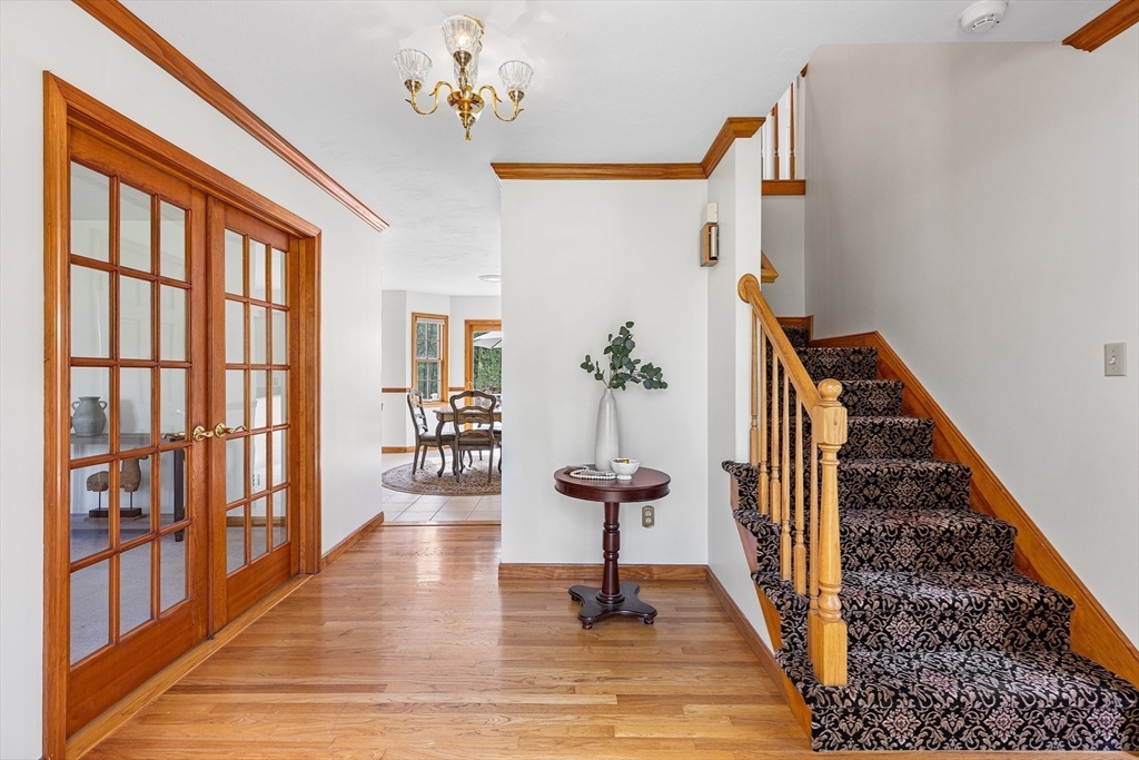 3 Wildflower Drive Sutton, MA 01590 - Photo 5 of 31 a view of a hallway with wooden floor and staircase
