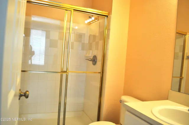 a bathroom with a shower and a toilet