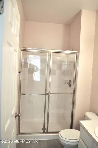 a white toilet sitting next to a bathroom sink