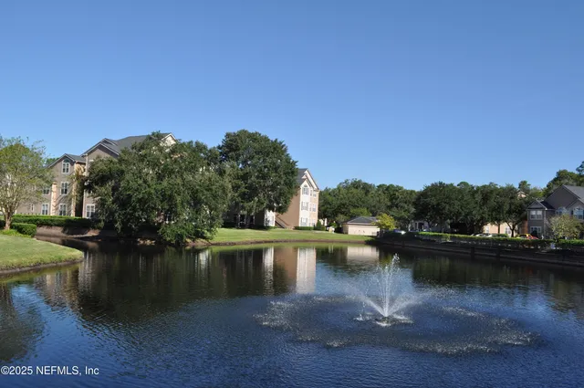 a view of a lake with boats and trees in the background