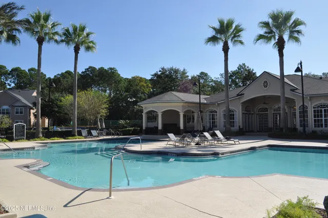a front view of a house with swimming pool having outdoor seating