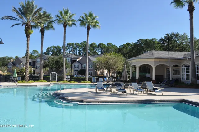 a front view of a house with swimming pool having outdoor seating