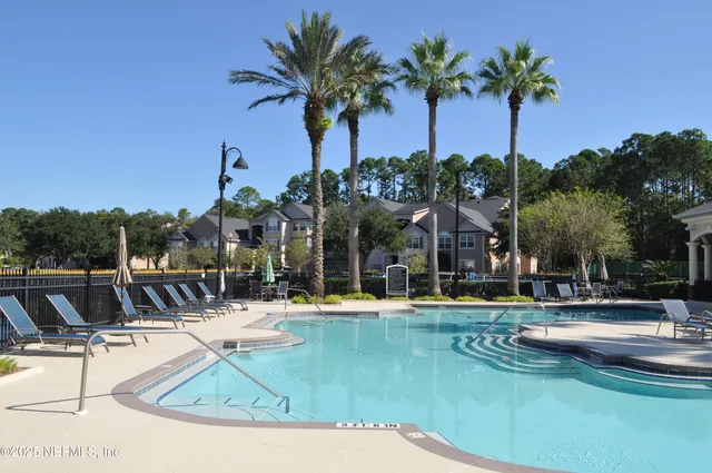 a view of a swimming pool with a table and chairs