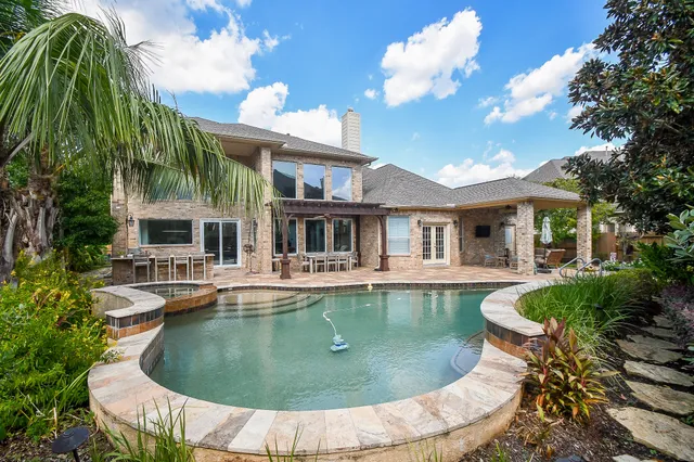 a view of a house with swimming pool and sitting area
