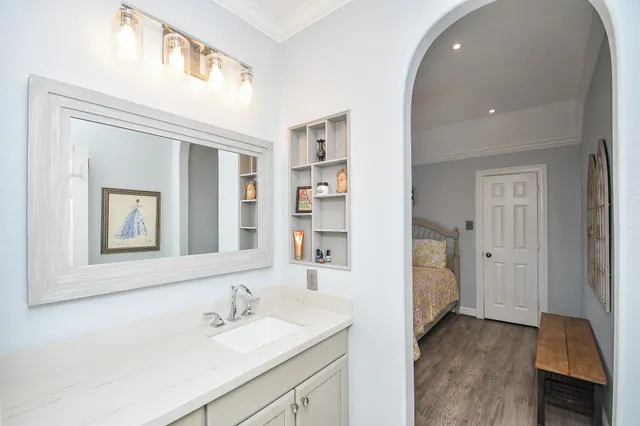 a en suite bathroom with a sink and a mirror