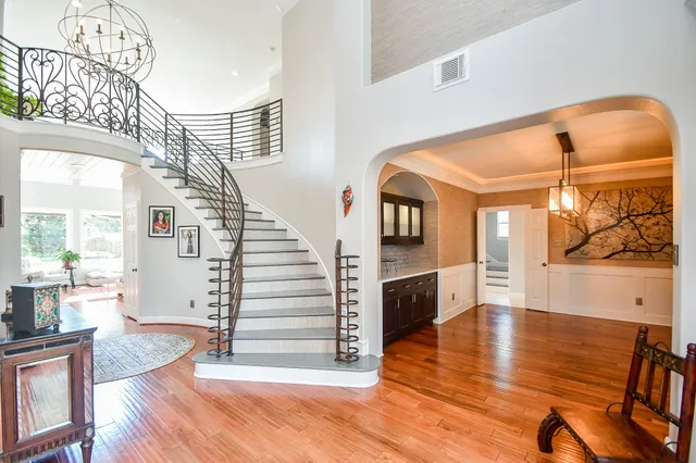 a view of entryway and hall with wooden floor
