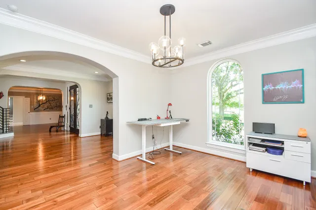 a view of kitchen with white cabinets and wooden floor