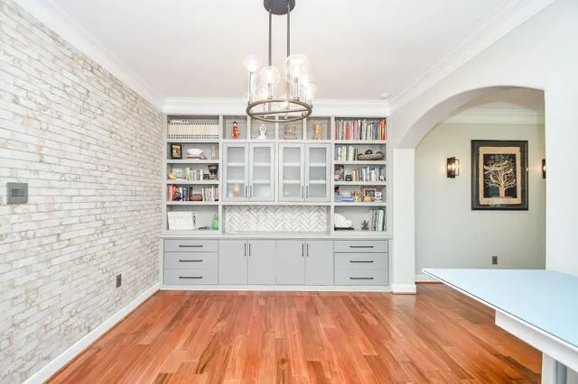 a view of a kitchen with wooden floor and cabinets