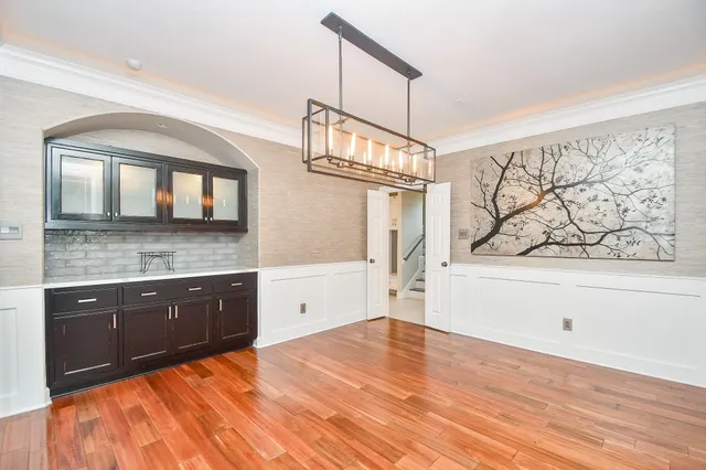 a living room with furniture wooden floor and a rug