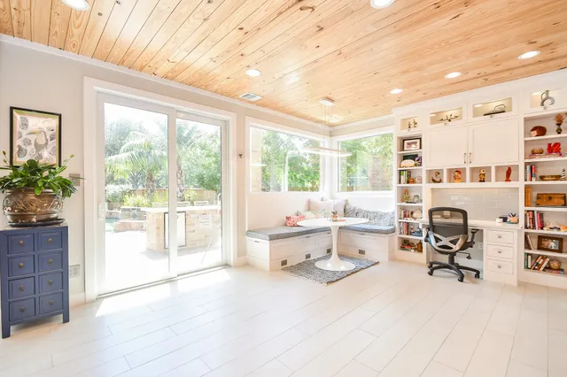 a view of a kitchen with kitchen island a counter top space a sink stainless steel appliances and cabinets