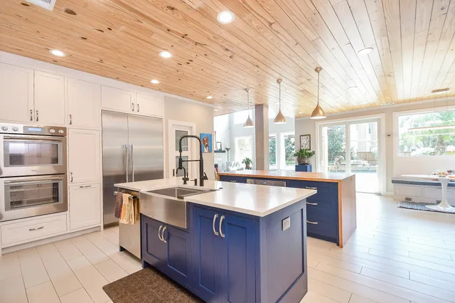 a kitchen with stainless steel appliances granite countertop a sink a stove and a refrigerator