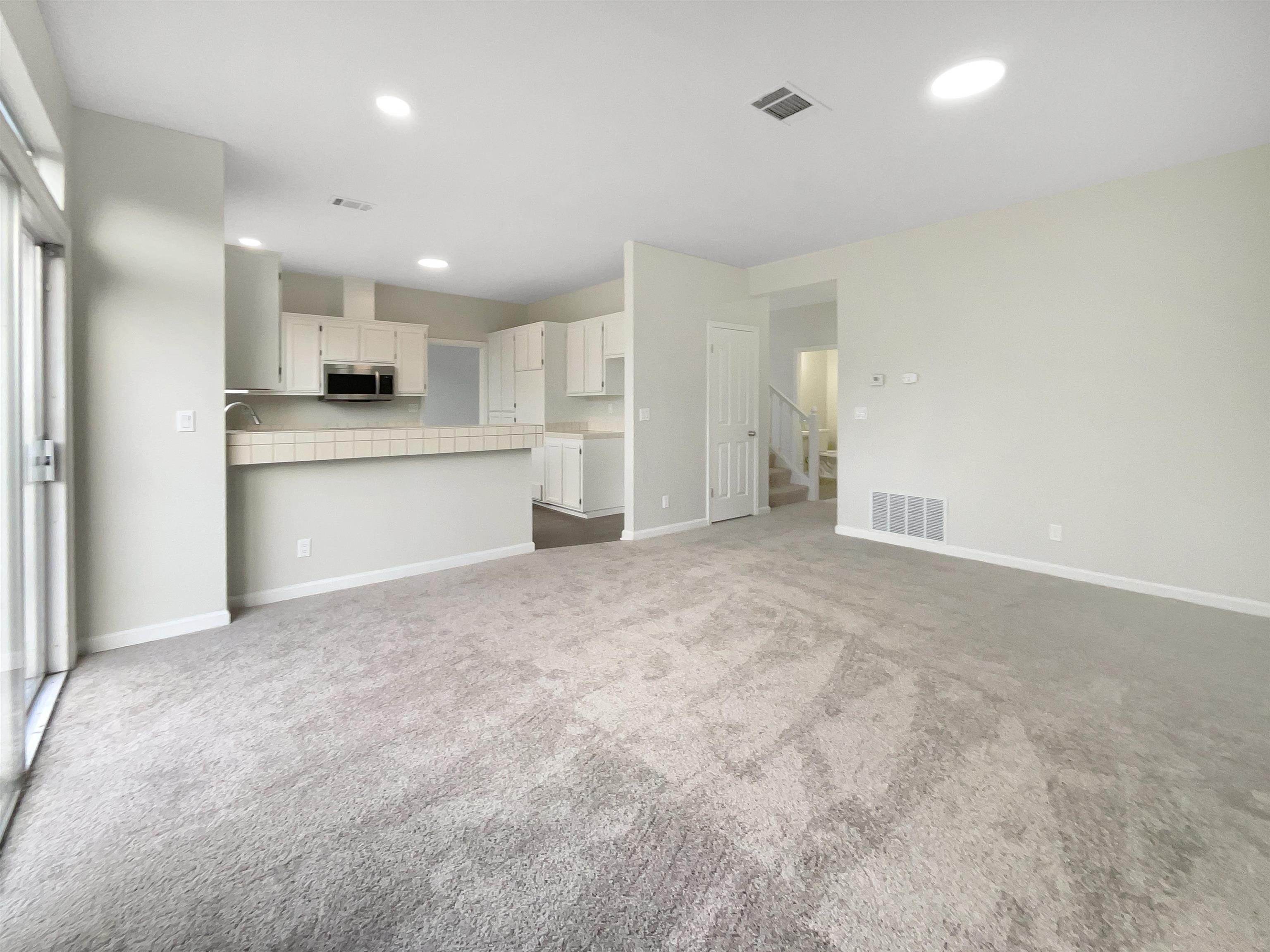 1474 Rutherford Lane Oakley, CA 94561 - Photo 14 of 31 Unfurnished living room featuring dark colored carpet and recessed lighting