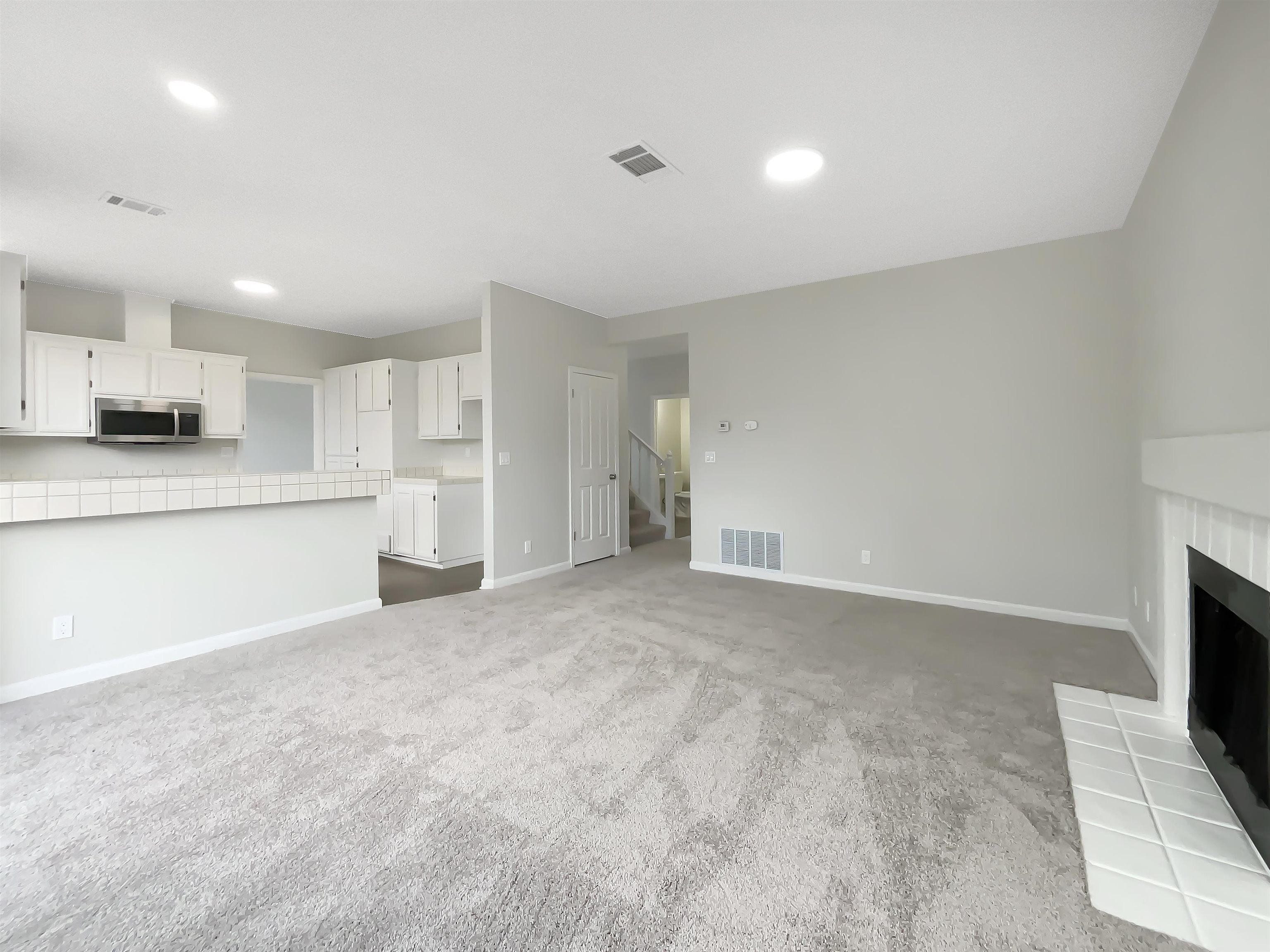1474 Rutherford Lane Oakley, CA 94561 - Photo 15 of 31 Unfurnished living room with a fireplace, dark colored carpet, and recessed lighting