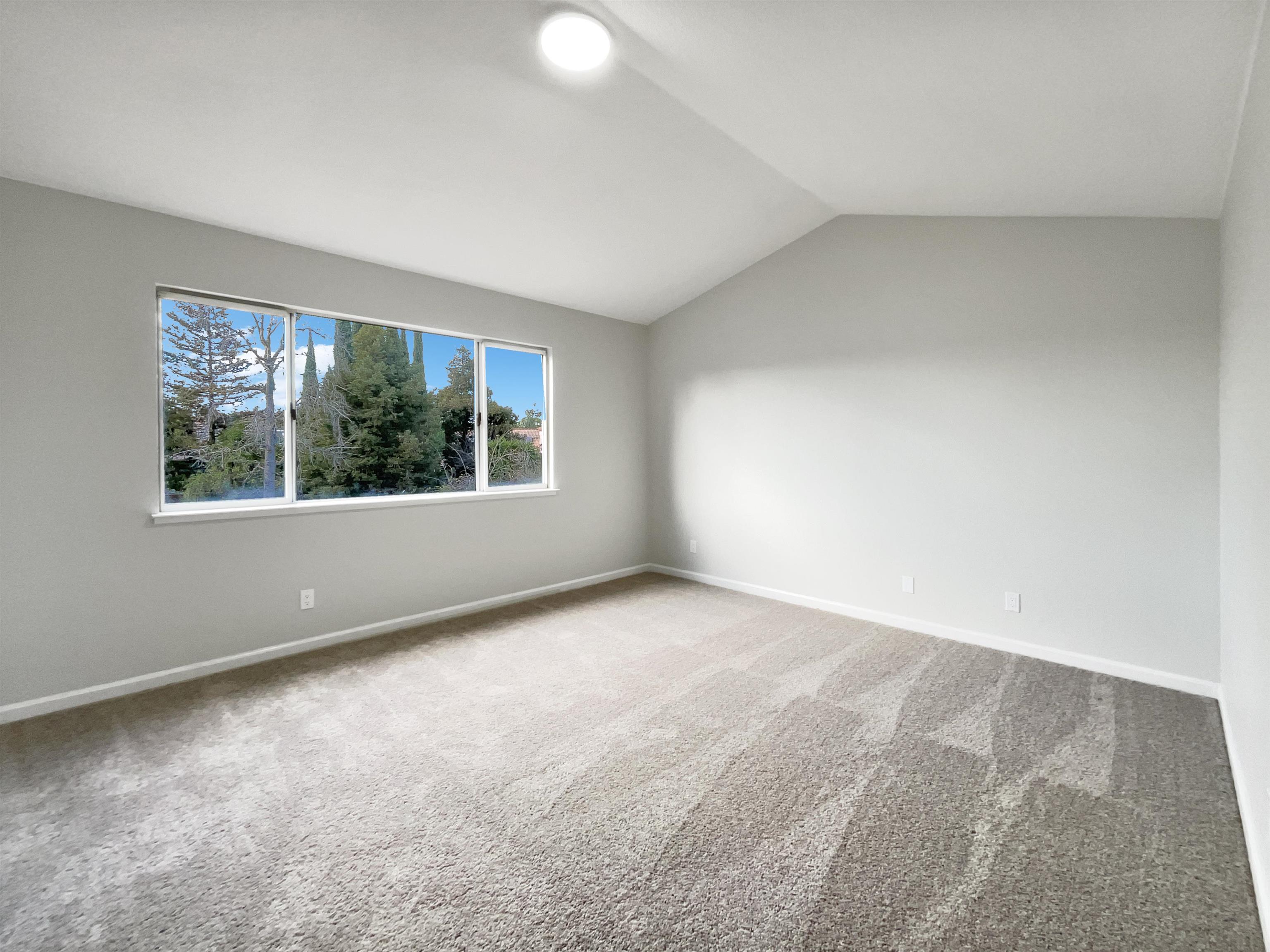 1474 Rutherford Lane Oakley, CA 94561 - Photo 22 of 31 Spare room featuring light colored carpet and vaulted ceiling