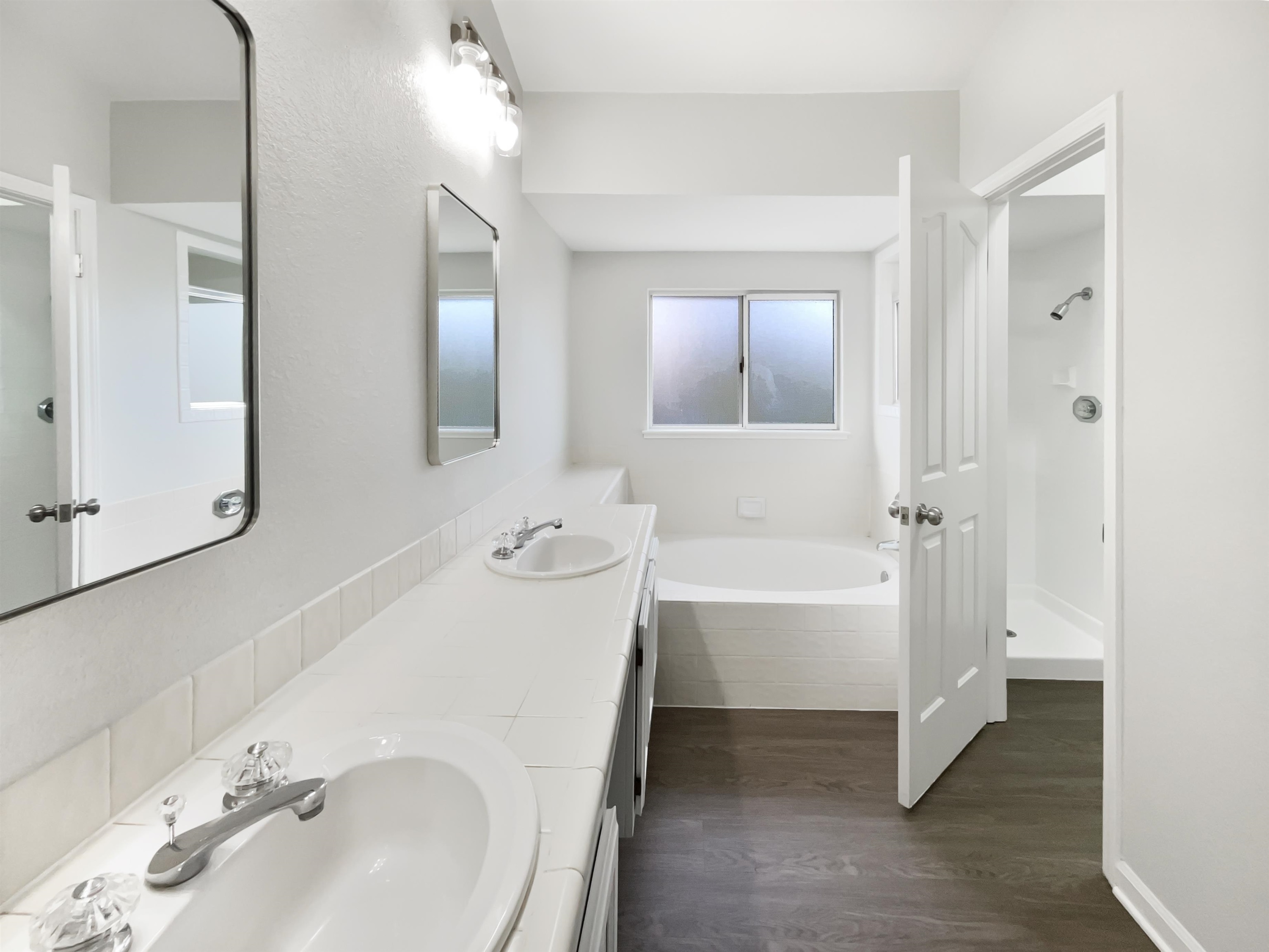 1474 Rutherford Lane Oakley, CA 94561 - Photo 28 of 31 Full bathroom with a bath, double vanity, dark wood-style floors, a baseboard heating unit, and a shower