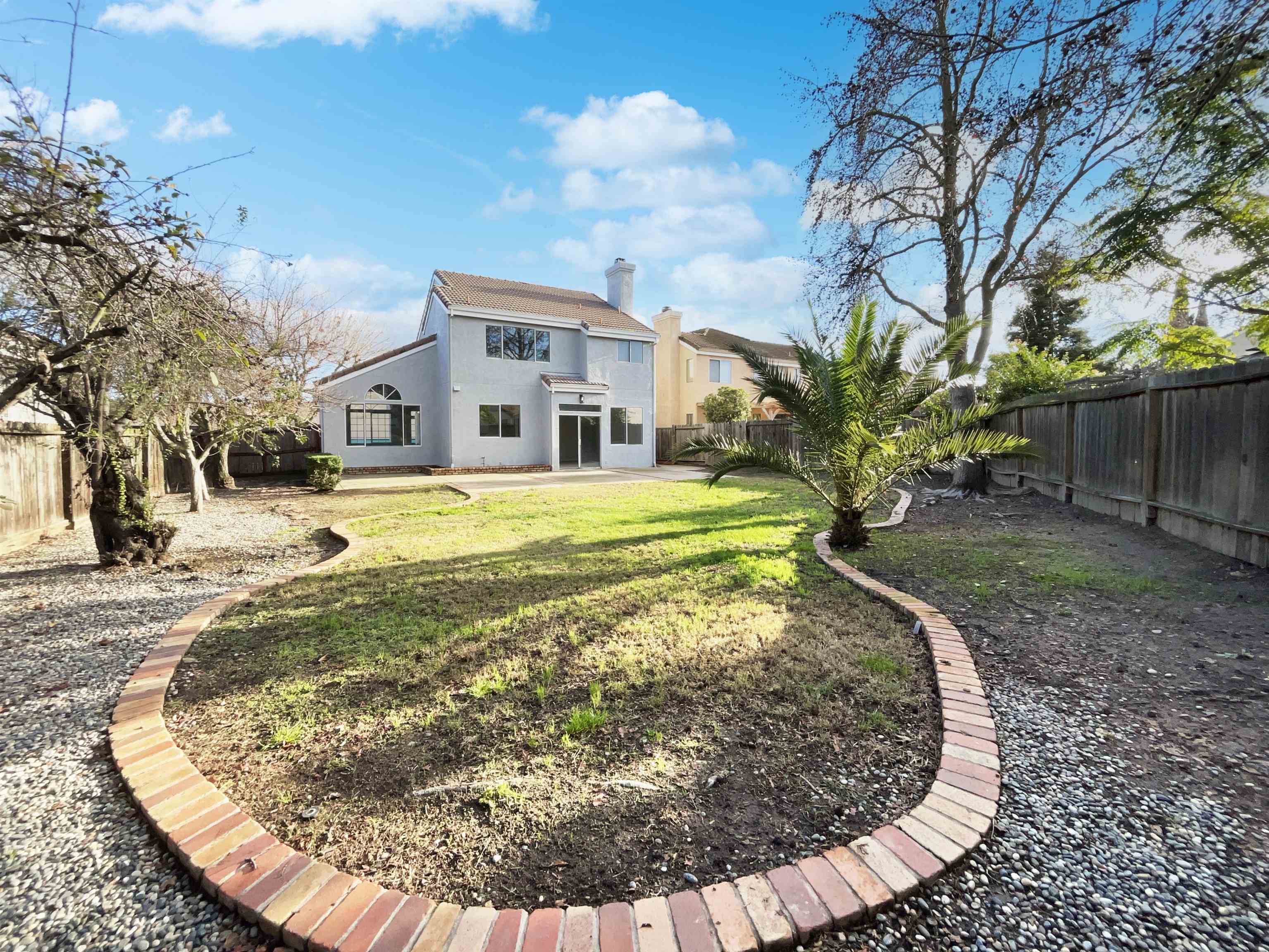 1474 Rutherford Lane Oakley, CA 94561 - Photo 30 of 31 Rear view of house featuring a fenced backyard, a chimney, a patio area, and stucco siding