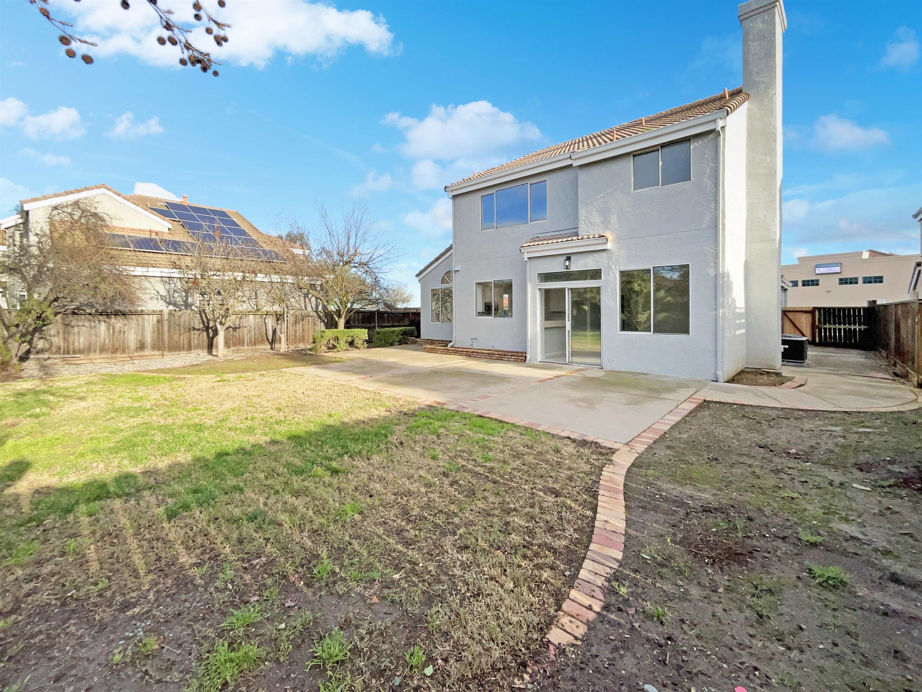 1474 Rutherford Lane Oakley, CA 94561 - Photo 6 of 31 Back of property featuring a fenced backyard, a chimney, a tile roof, and stucco siding