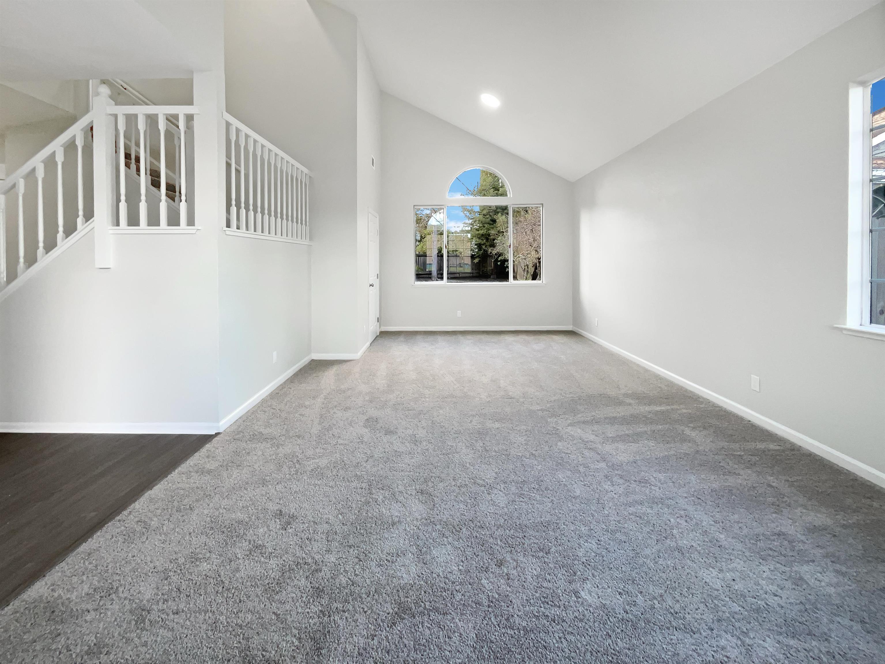 1474 Rutherford Lane Oakley, CA 94561 - Photo 8 of 31 Unfurnished living room with vaulted ceiling and carpet flooring
