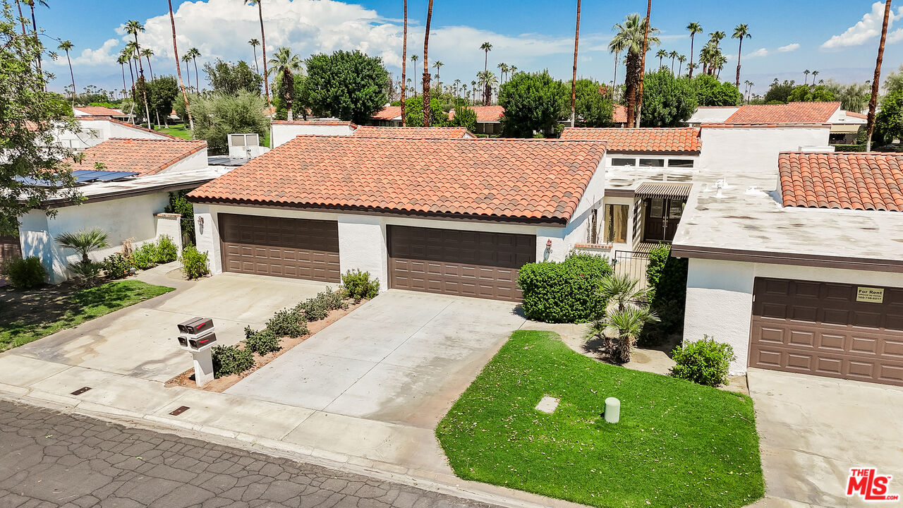 109 Torremolinos Drive Rancho Mirage, CA 92270 - Photo 2 of 39 a view of a house with a yard and potted plants