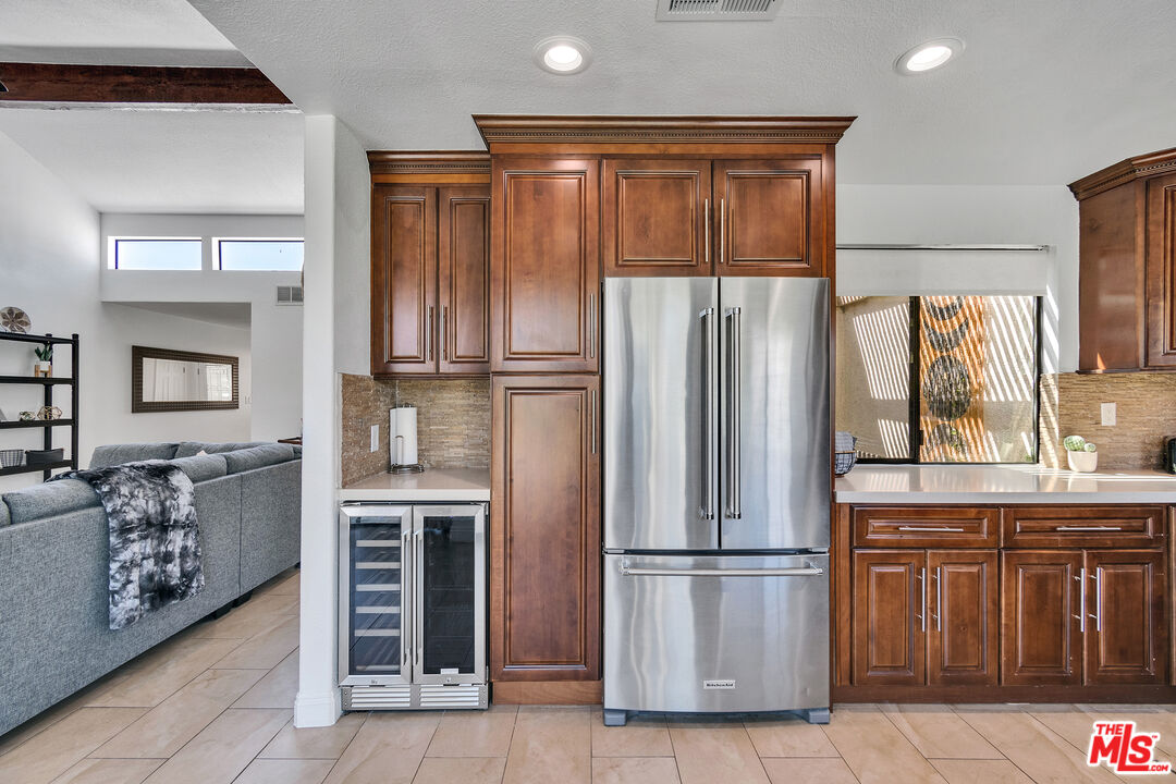 109 Torremolinos Drive Rancho Mirage, CA 92270 - Photo 26 of 39 a kitchen with stainless steel appliances granite countertop a refrigerator and a sink