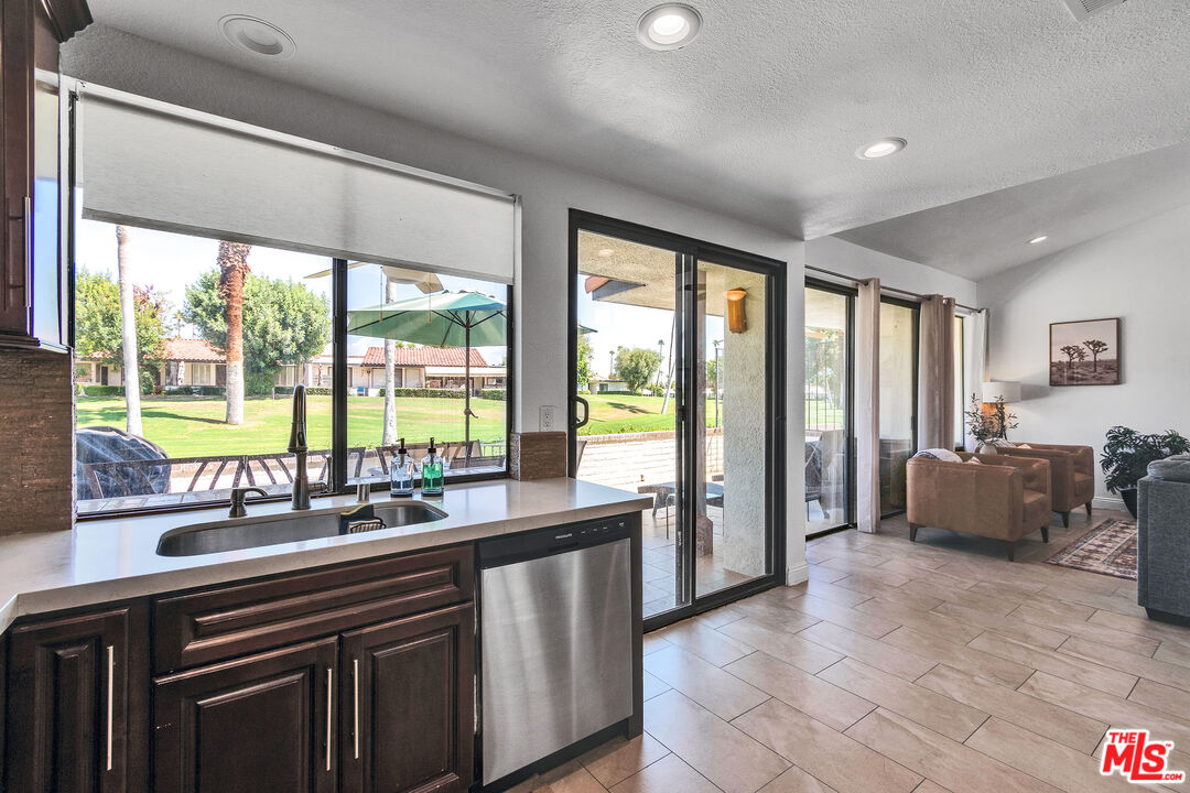 109 Torremolinos Drive Rancho Mirage, CA 92270 - Photo 29 of 39 a view of a kitchen with a sink and large windows