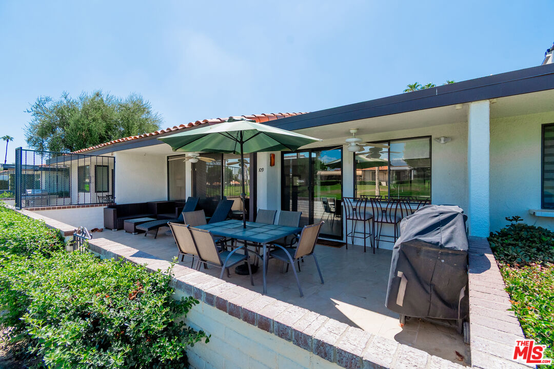 109 Torremolinos Drive Rancho Mirage, CA 92270 - Photo 30 of 39 a view of a patio with table and chairs under an umbrella