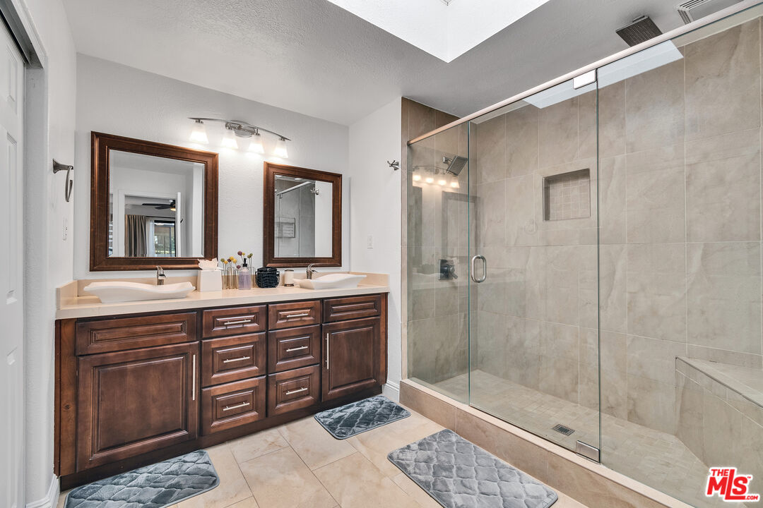 109 Torremolinos Drive Rancho Mirage, CA 92270 - Photo 9 of 39 a spacious bathroom with a shower sink and mirror