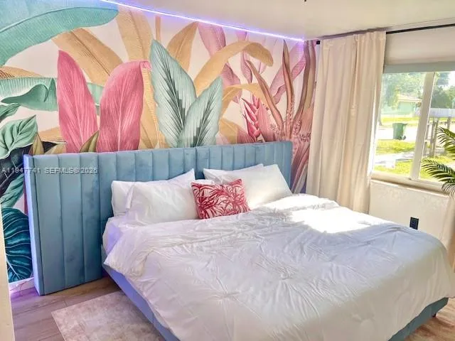 a bedroom with a bed and a window