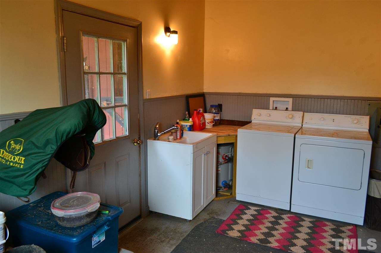 344 Neodak Road Apex, NC 27523 - Photo 18 of 25 Tack room utility sink, bridle hooks and three saddle racks.