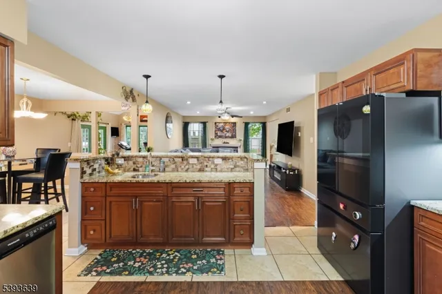 a kitchen with stainless steel appliances granite countertop a stove and a refrigerator