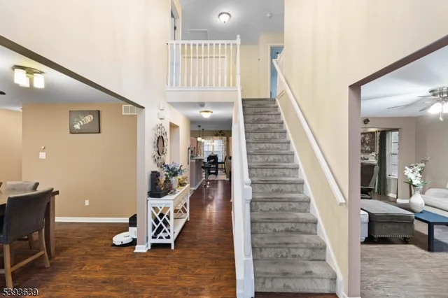 a view of a livingroom with furniture and staircase