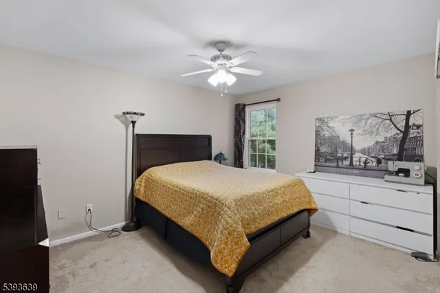 a bed sitting in a bedroom and chandelier