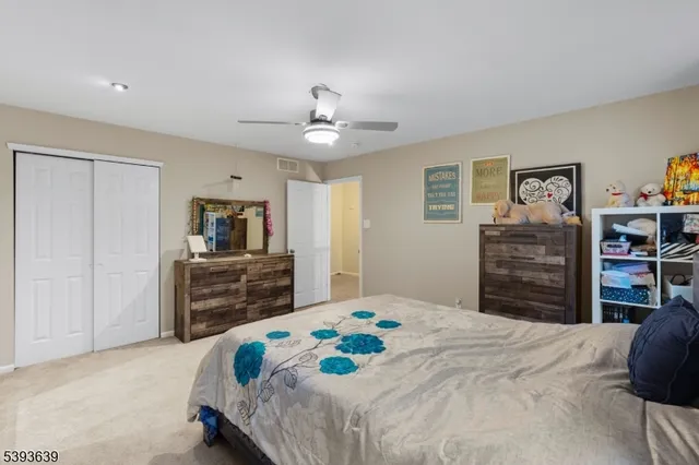 a bedroom with a bed a dresser and a television