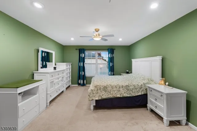 a spacious bedroom with a bed and a dresser