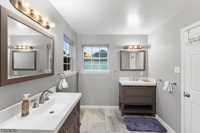 a bathroom with a double vanity sink mirror and