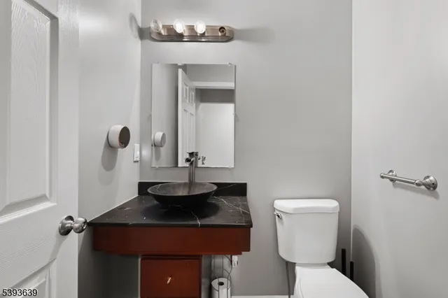 a bathroom with a sink a toilet and mirror