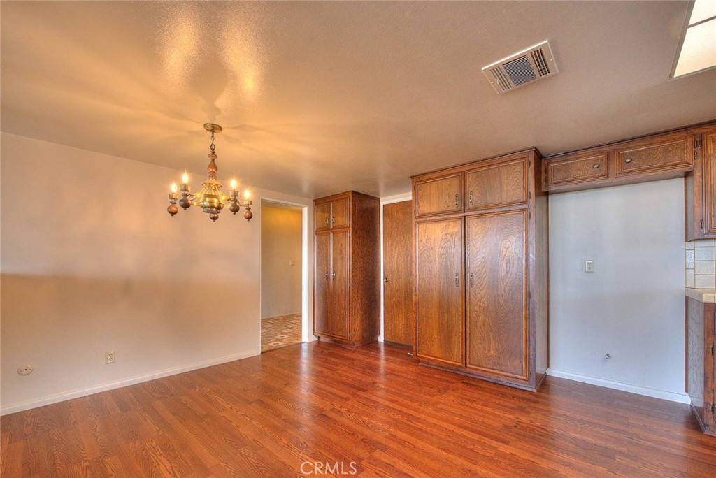 16464 Rancho Escondido Drive Riverside, CA 92506 - Photo 13 of 47 wooden floor in an empty room with a mirror