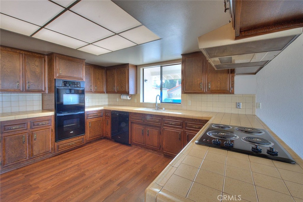 16464 Rancho Escondido Drive Riverside, CA 92506 - Photo 15 of 47 a kitchen with wooden floors and a sink
