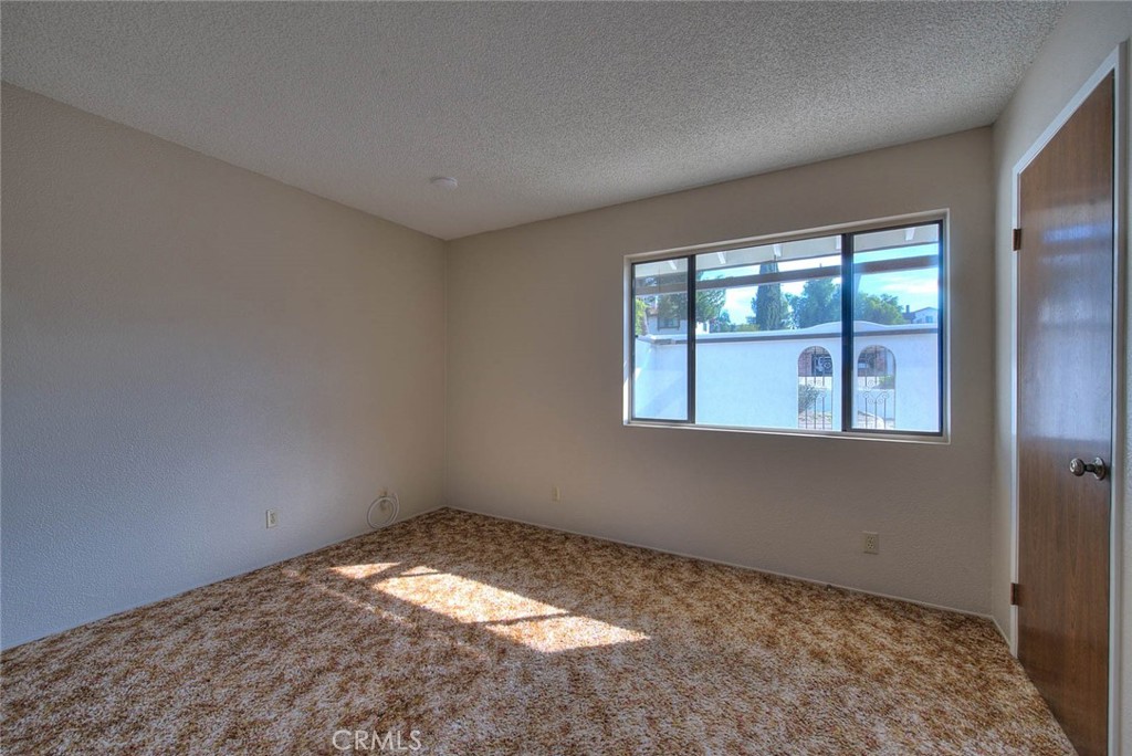 16464 Rancho Escondido Drive Riverside, CA 92506 - Photo 18 of 47 an empty room with a window