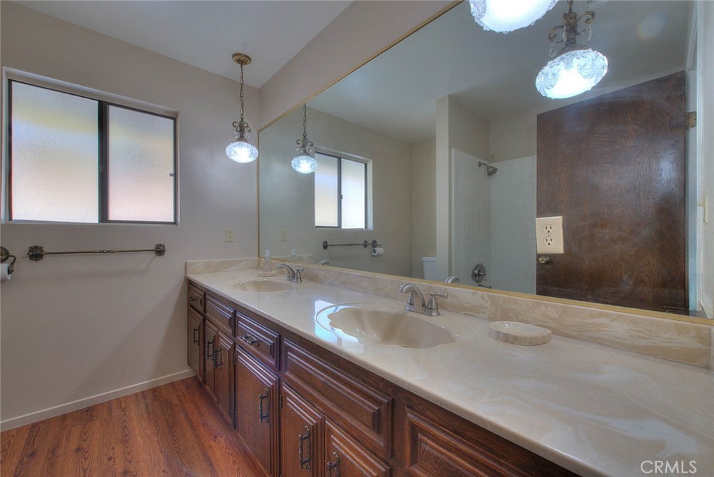 16464 Rancho Escondido Drive Riverside, CA 92506 - Photo 19 of 47 a bathroom with a sink and a mirror