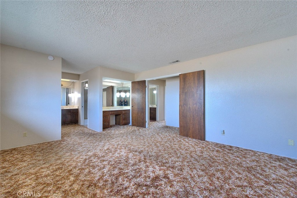 16464 Rancho Escondido Drive Riverside, CA 92506 - Photo 21 of 47 a view of a big room with closet and windows
