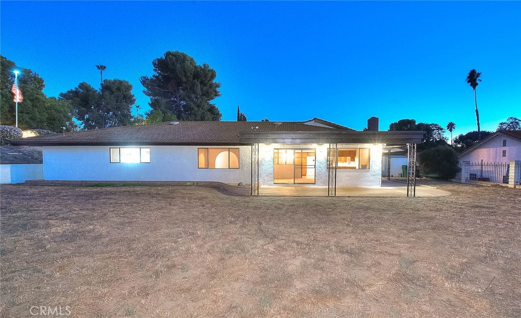 16464 Rancho Escondido Drive Riverside, CA 92506 - Photo 28 of 47 a view of a house with a yard and a large tree