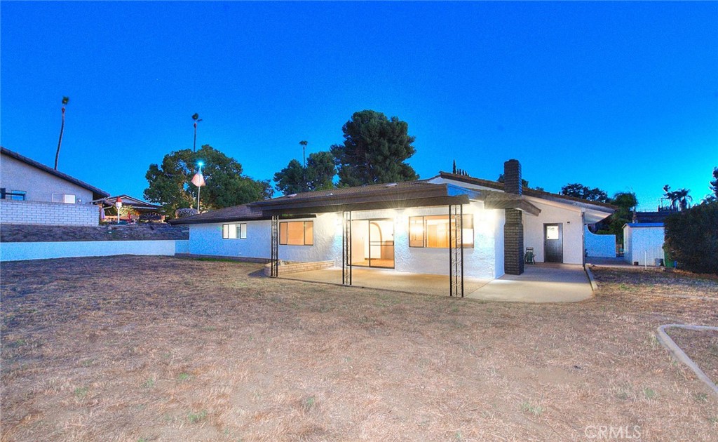 16464 Rancho Escondido Drive Riverside, CA 92506 - Photo 30 of 47 a view of a house with a yard and potted plants