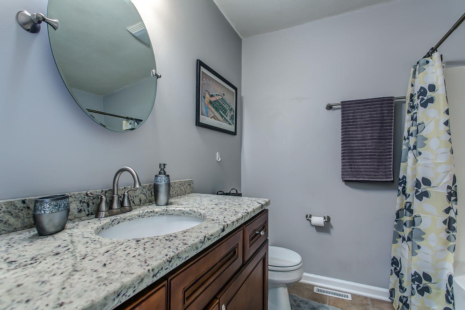 410 Jackson Road Portland, TN 37148 - Photo 14 of 22 a bathroom with a granite countertop sink and a mirror