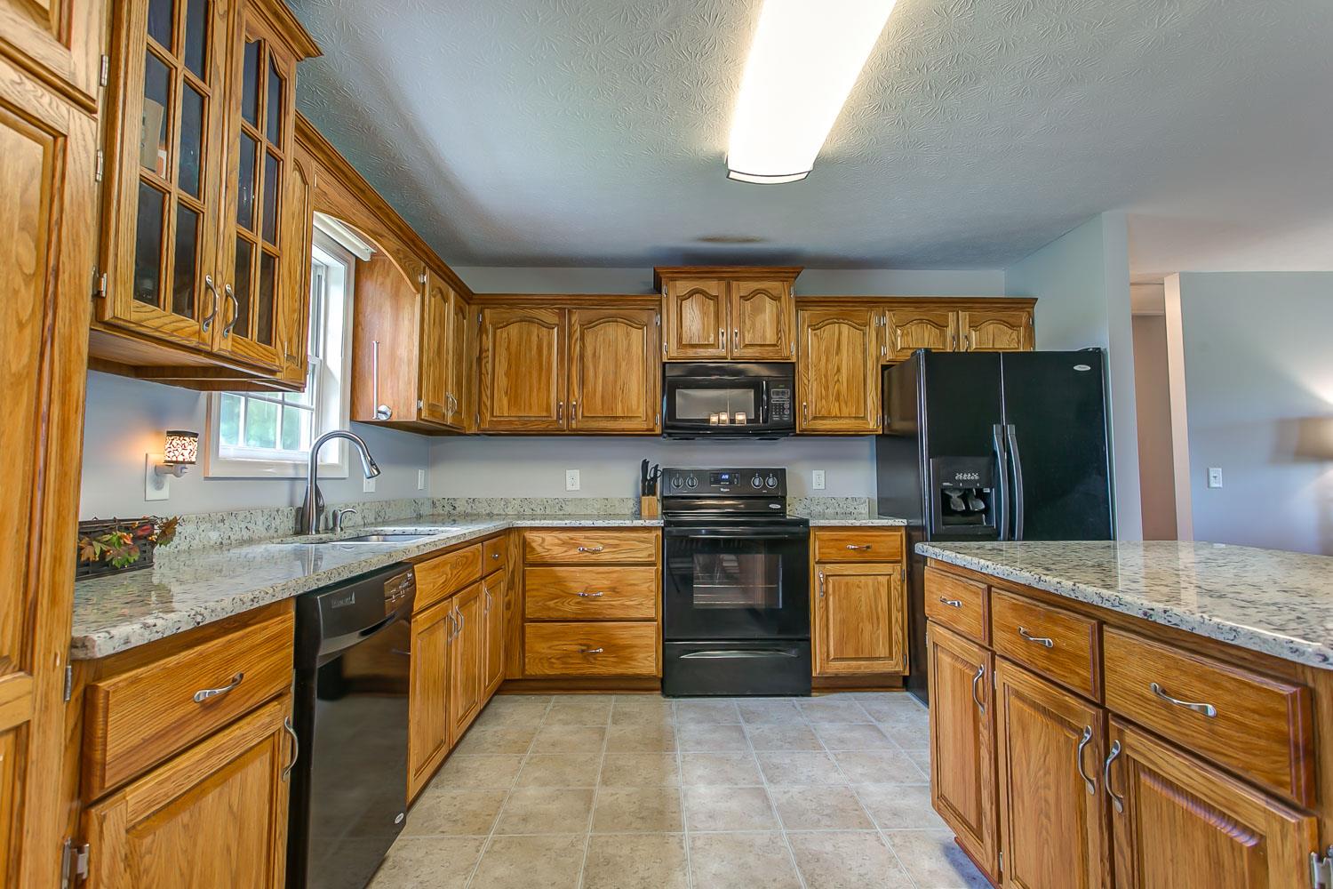 410 Jackson Road Portland, TN 37148 - Photo 3 of 22 a kitchen with stainless steel appliances granite countertop a stove sink and cabinets