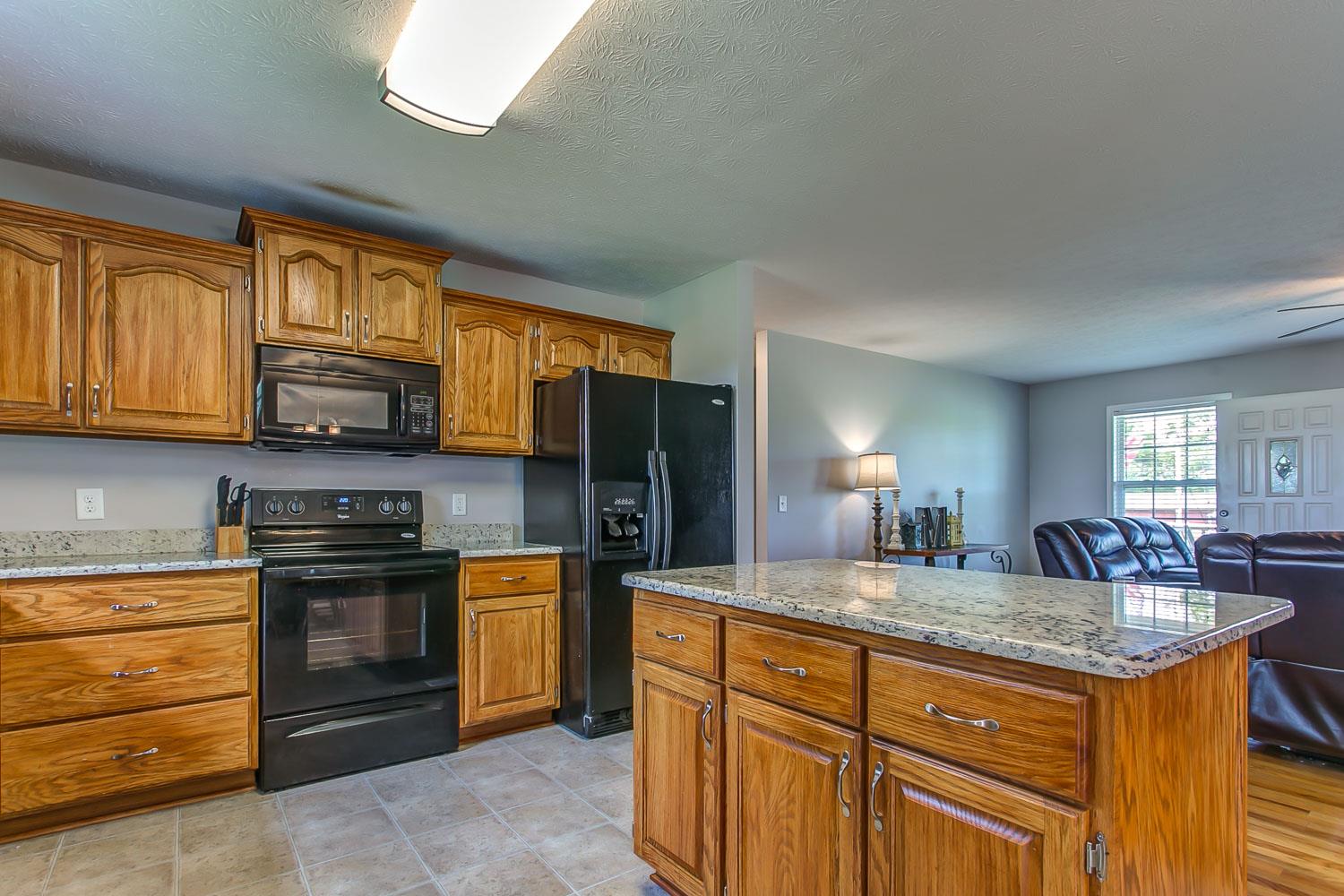 410 Jackson Road Portland, TN 37148 - Photo 7 of 22 a kitchen with stainless steel appliances granite countertop a stove a sink and a refrigerator
