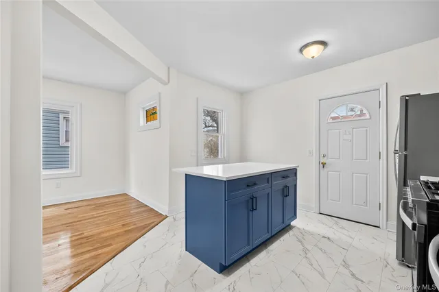 a room with a dresser and a window