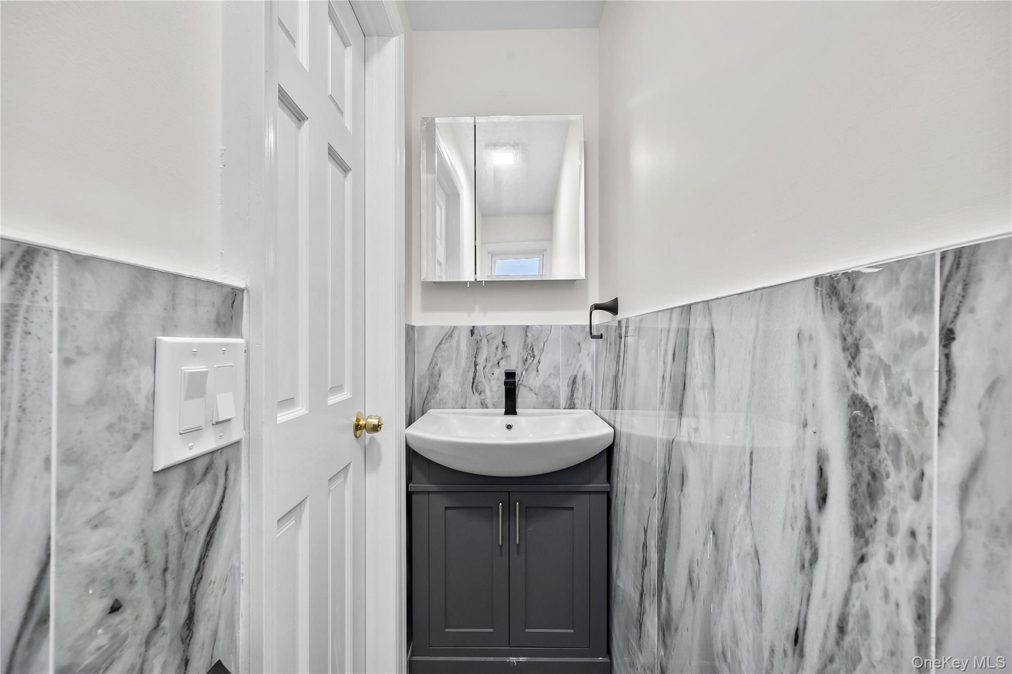115-12 197th Street Queens, NY 11412 - Photo 12 of 26 a bathroom with a sink a mirror and a shower